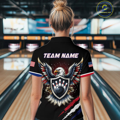 Person wearing a black bowling shirt with eagle design and 'Team Name' text in a bowling alley.