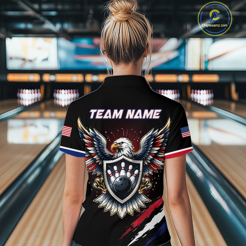 Person wearing a black bowling shirt with eagle design and 'Team Name' text in a bowling alley.