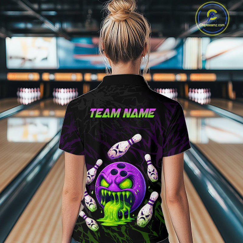 Person wearing a black bowling shirt with colorful design and 'TEAM NAME' text in a bowling alley.