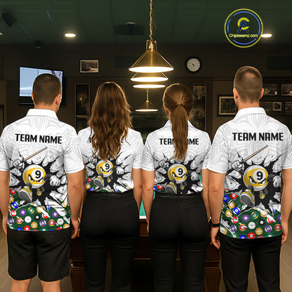 Four people wearing matching bowling team shirts in a bowling alley.