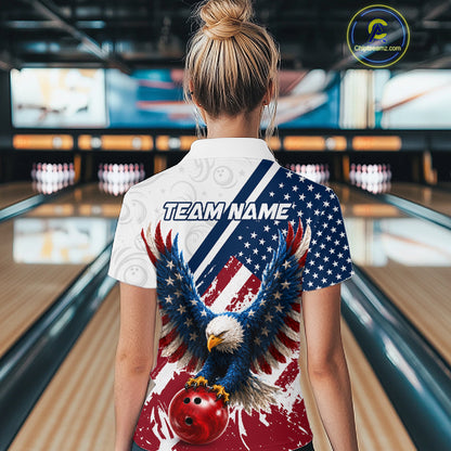 A woman viewed from behind wearing a short-sleeve collared bowling shirt with a patriotic American flag design, featuring a bald eagle and bowling ball graphic, in a bowling alley.
