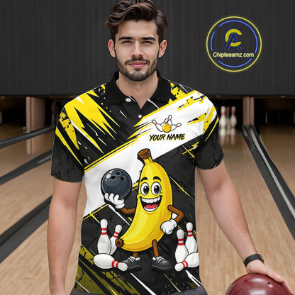 Man wearing a bowling-themed shirt with a cartoon banana character in a bowling alley.