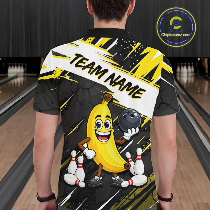 Man wearing a bowling-themed shirt with a cartoon banana character in a bowling alley.