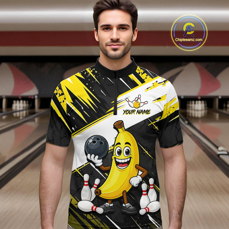 Man wearing a bowling-themed shirt with a banana character in a bowling alley.
