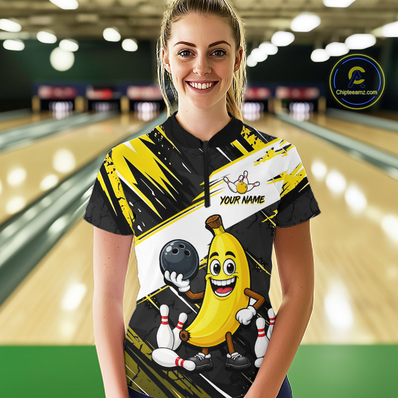 Women wearing a bowling shirt with a cartoon banana character on a bowling alley.