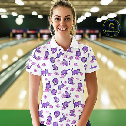 Woman wearing a white polo shirt with purple cat pattern in a bowling alley.
