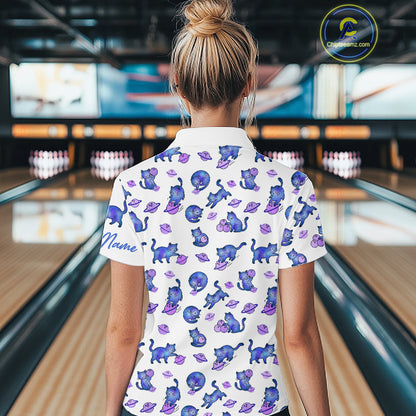 Woman wearing a white shirt with blue cat pattern in a bowling alley.