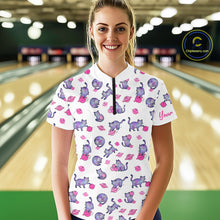 Load image into Gallery viewer, Woman wearing a white bowling shirt with pink cat pattern in a bowling alley.