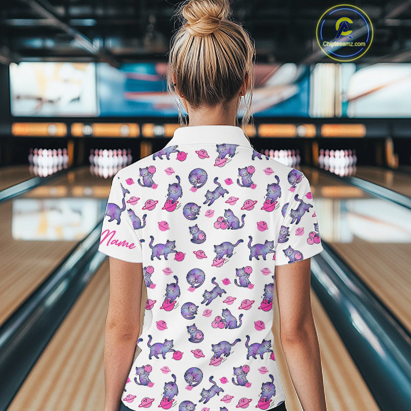 Woman wearing a white shirt with pink cat pattern in a bowling alley.