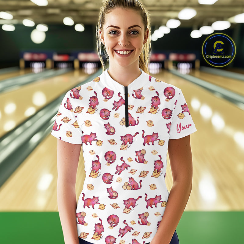 Woman wearing a white shirt with red cat pattern in a bowling alley
