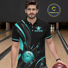 Load image into Gallery viewer, Man wearing a black and teal bowling-themed shirt with a bowling alley in the background