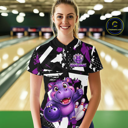 Woman wearing of a black, white, and purple bowling quarter zip shirt featuring a cheerful purple hippo holding a bowling ball, with custom player name text.