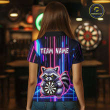 Load image into Gallery viewer, Women wearing darts polo shirt featuring a raccoon holding a dartboard framed by neon light effects on a black background.