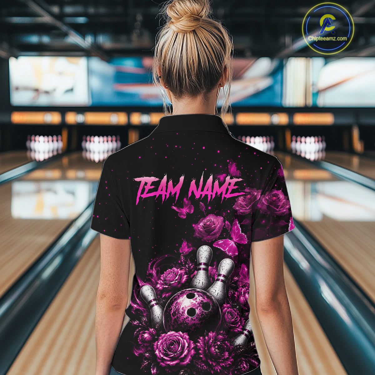 Women’s pink rose butterfly bowling quarter zip shirt, back view on female model in bowling lane 