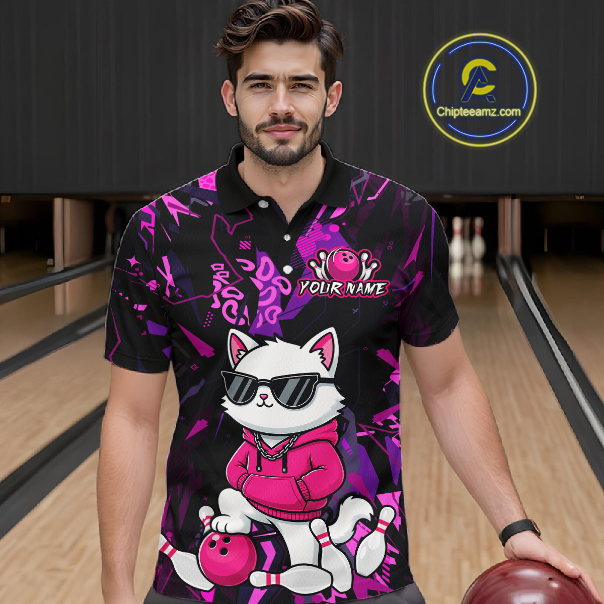 A man wearing a black and purple bowling-themed short-sleeve polo shirt with a cartoon cat graphic, standing in a bowling alley holding a bowling ball. A circular 'Chipleamz.