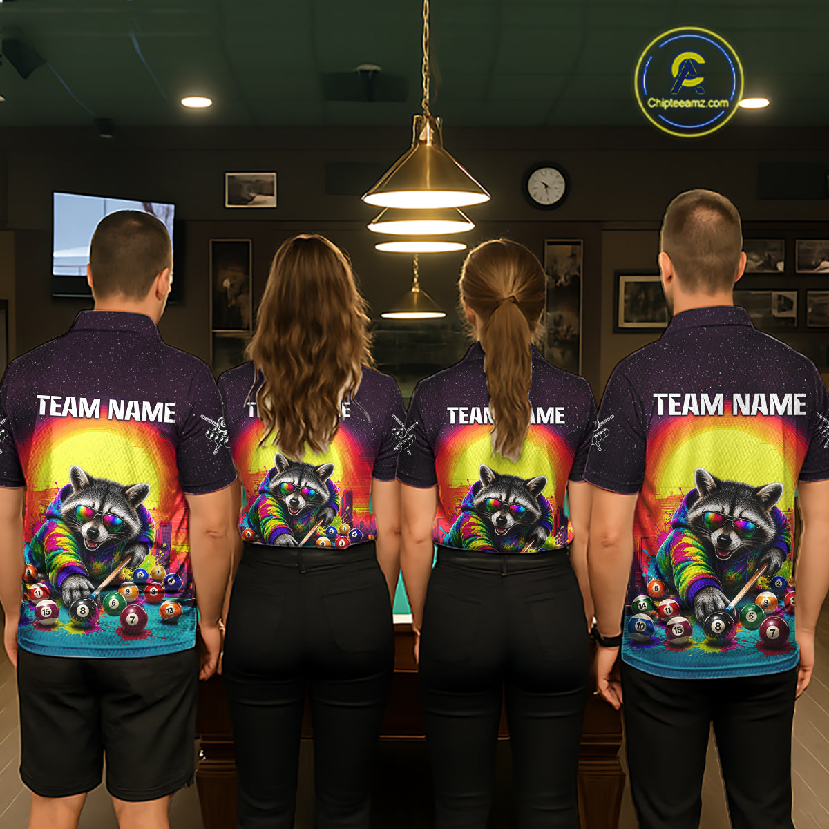Four people wearing matching shirts with a colorful raccoon design in a pool hall.