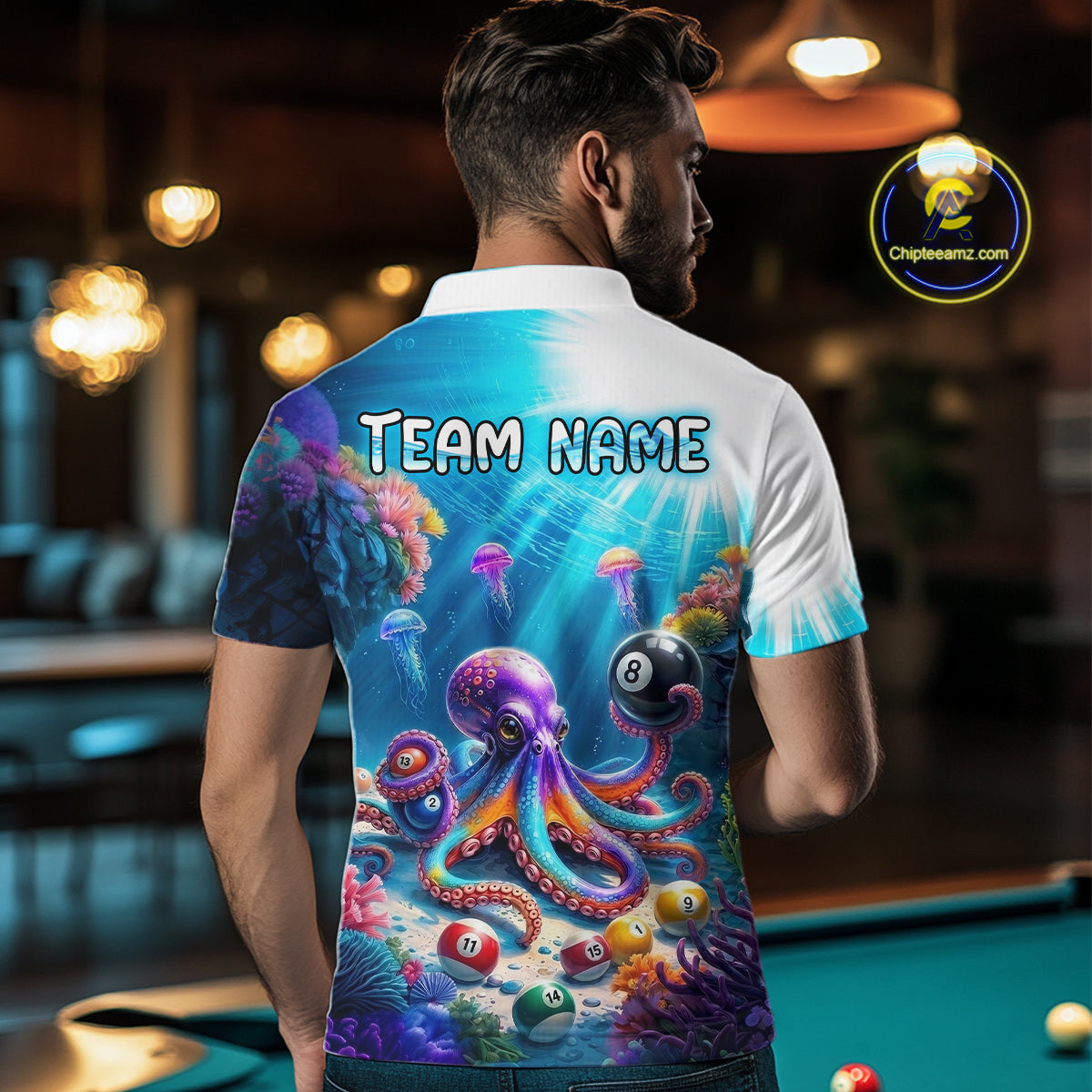 Person wearing a shirt with an octopus and pool ball design, standing in a bar.