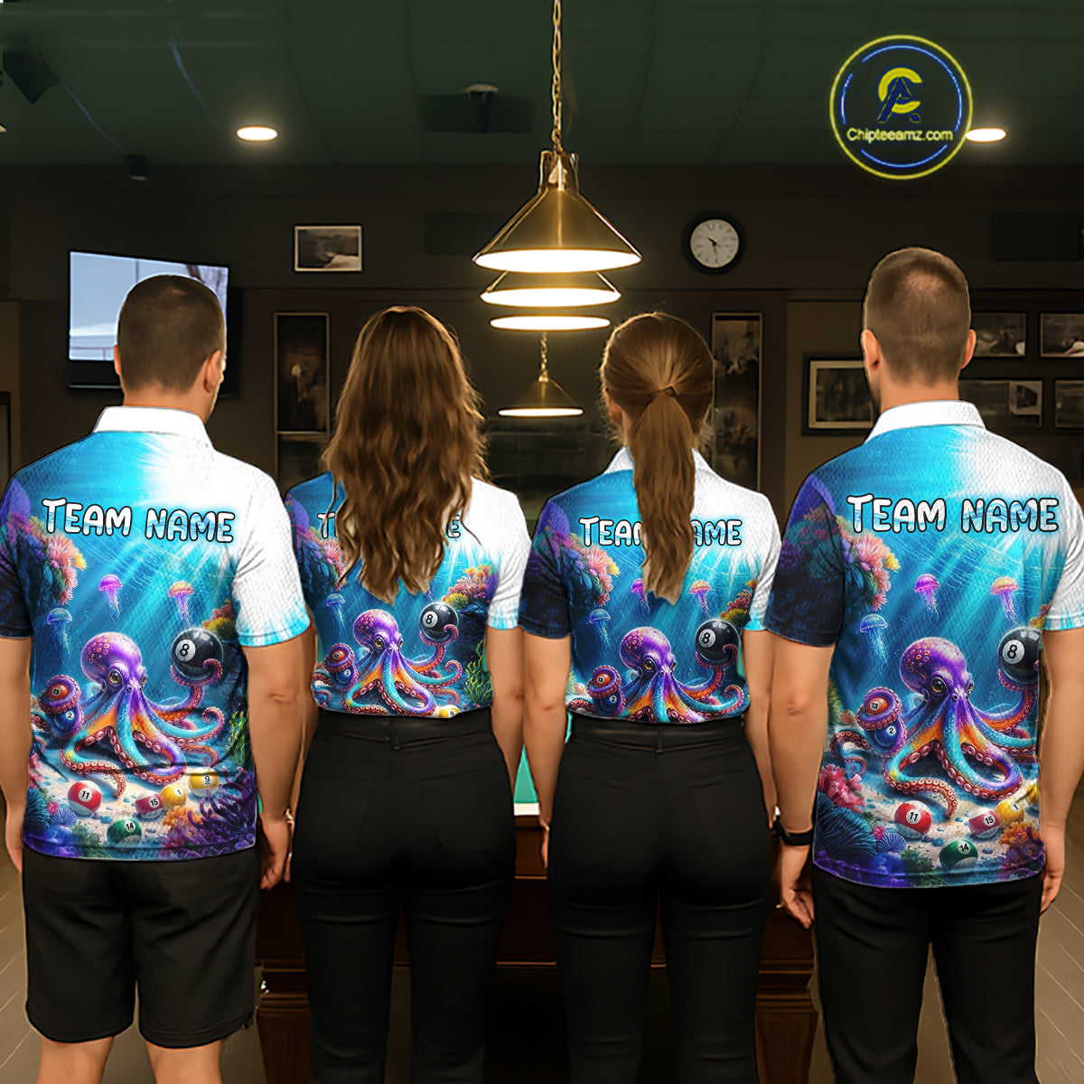 Four people wearing matching colorful shirts with an octopus design in a room.