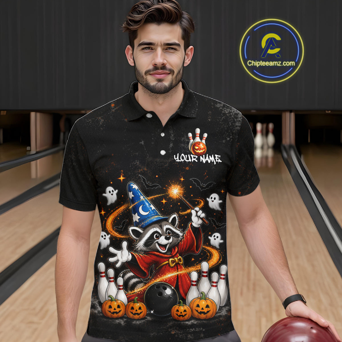 A man wearing a black short-sleeve polo shirt with a colorful Halloween-themed graphic print featuring a raccoon, pumpkins, ghosts, bowling pins, and a wizard hat. The shirt has a custom name placeholder on the chest.