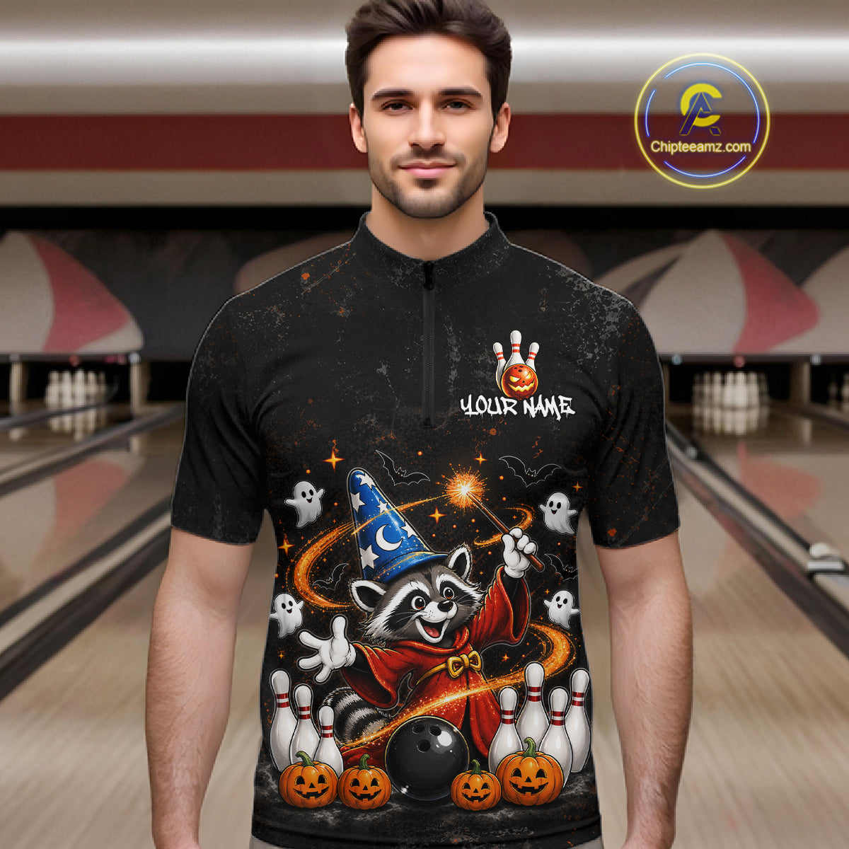A man wearing a black short-sleeve quarter-zip bowling shirt with a colorful Halloween graphic of a raccoon wizard, ghosts, pumpkins, and bowling pins, set against a blurred bowling alley background. A 'Chipeeamz.