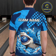 Load image into Gallery viewer, Person wearing a blue and gray shark-themed bowling shirt with 'TEAM NAME' text on a bowling alley background.