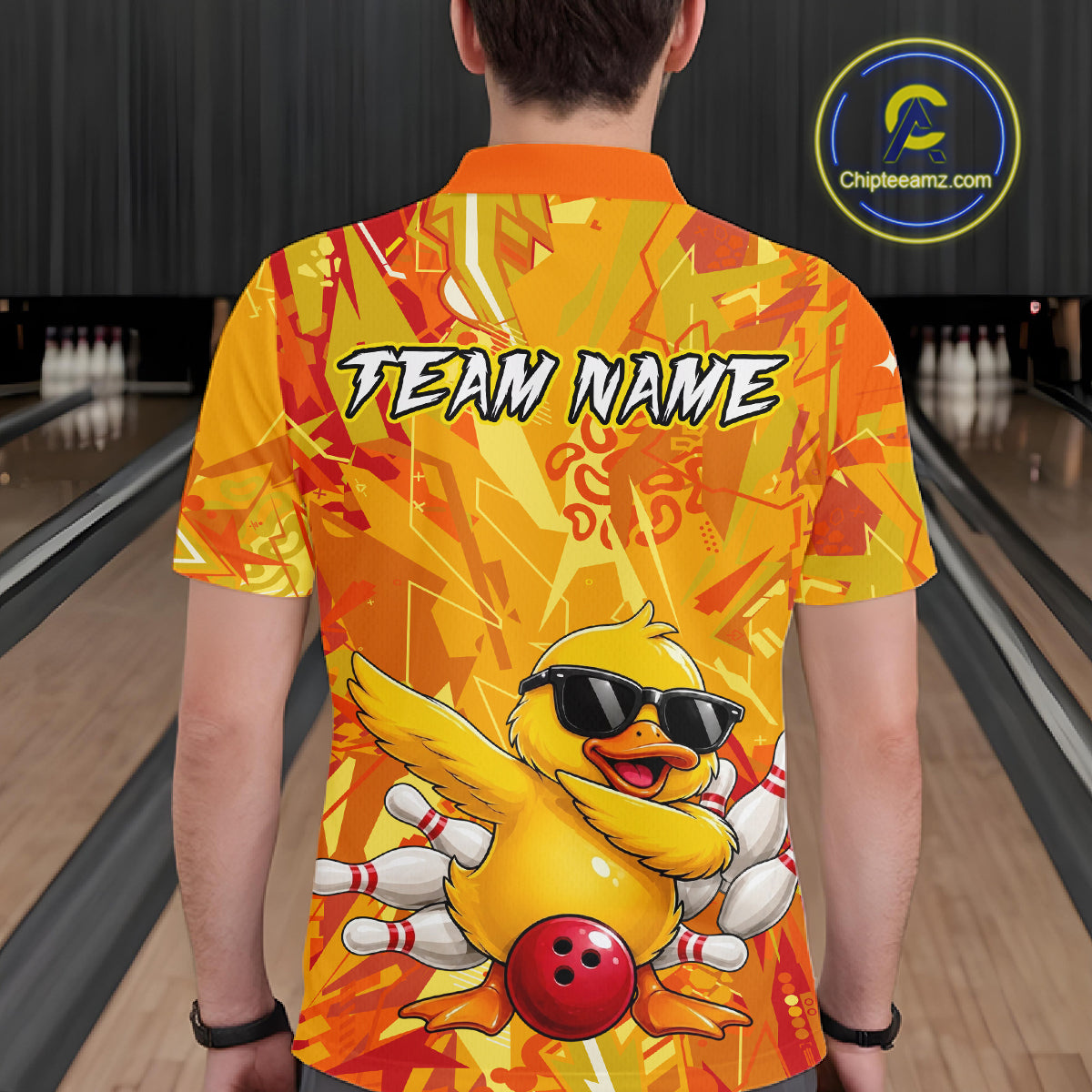 Person wearing a colorful bowling shirt with a duck graphic and 'Team Name' text in a bowling alley.