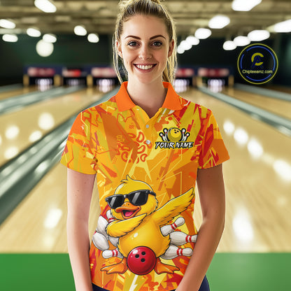 Person wearing a colorful bowling shirt with a duck design in a bowling alley.