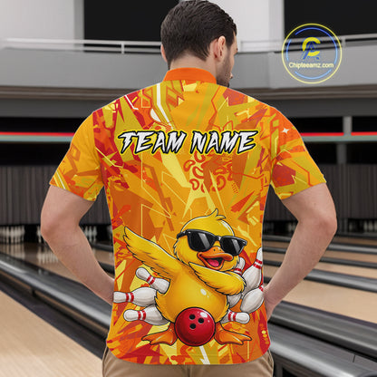 Person wearing a bright yellow bowling shirt with a duck design and 'Team Name' text, in a bowling alley.