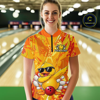 Person wearing a colorful bowling shirt with a duck design in a bowling alley.
