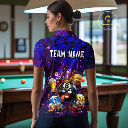 A woman stands with her back to the camera wearing a short-sleeve collared polo shirt with a colorful graphic print featuring billiard balls, beer mugs, and the text 'TEAM NAME'. The shirt has a purple and blue galaxy background with cartoon-style numbered balls.