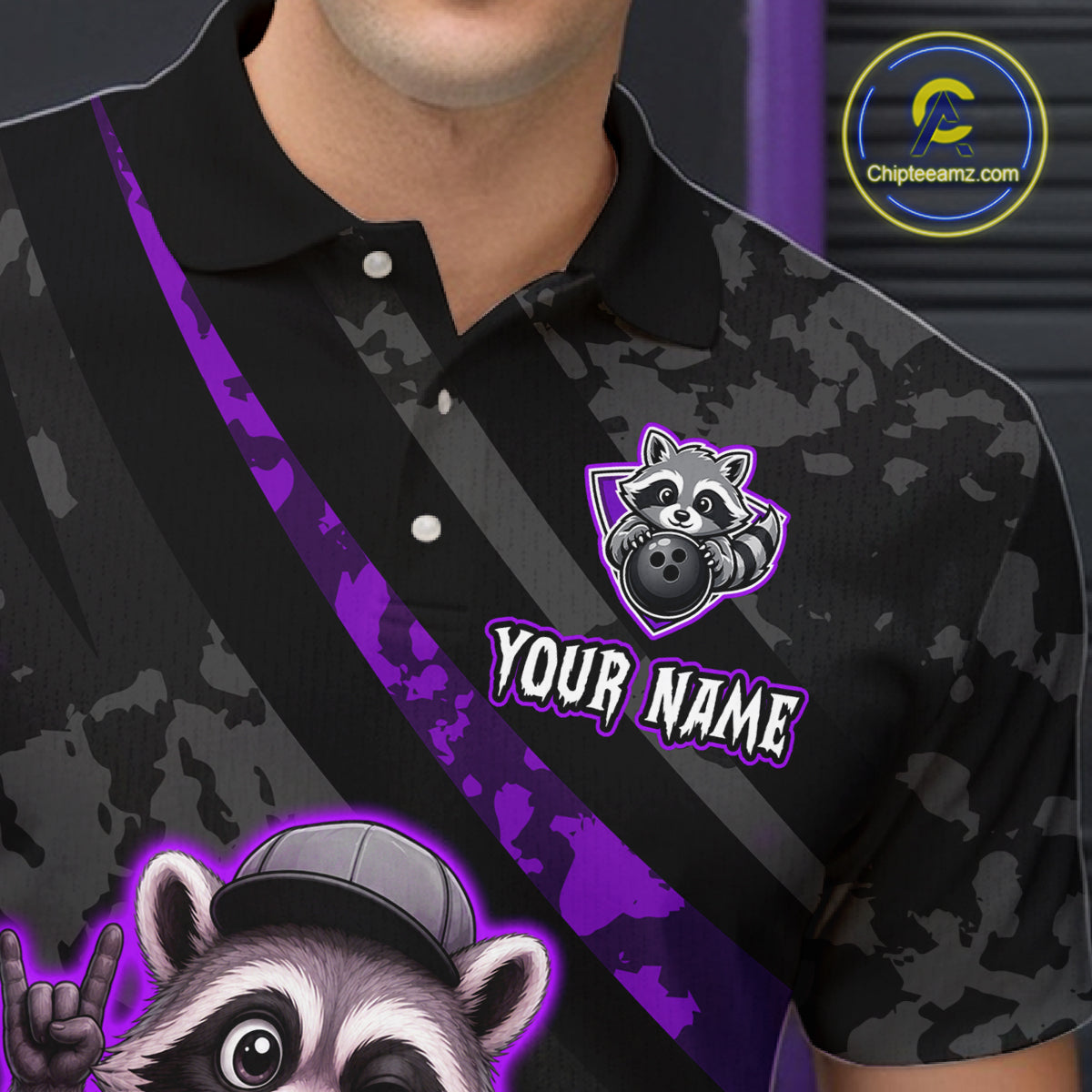 Black camouflage polo shirt with raccoon graphics and customizable text on a dark background