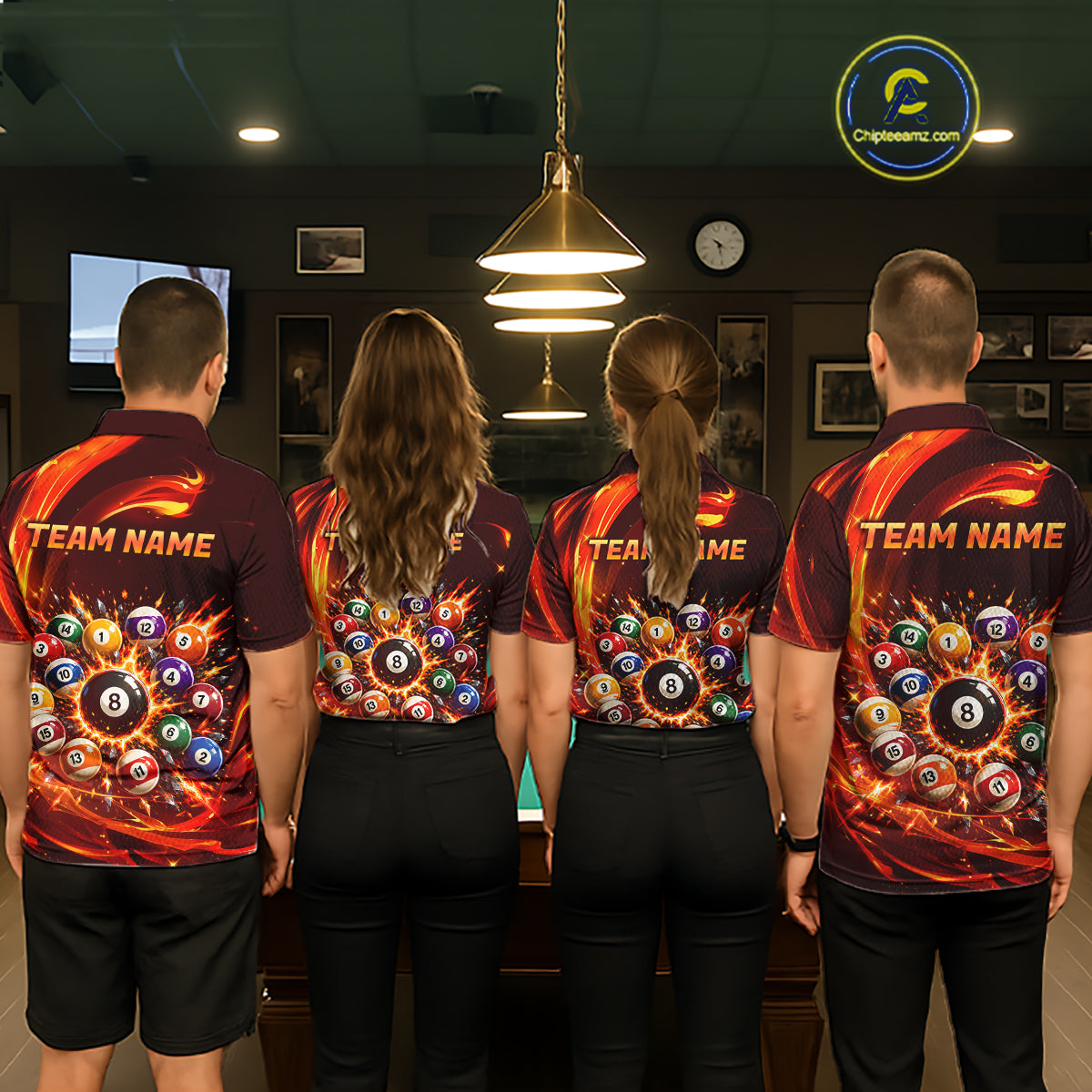 Four people wearing matching billiard team shirts in a bowling alley.