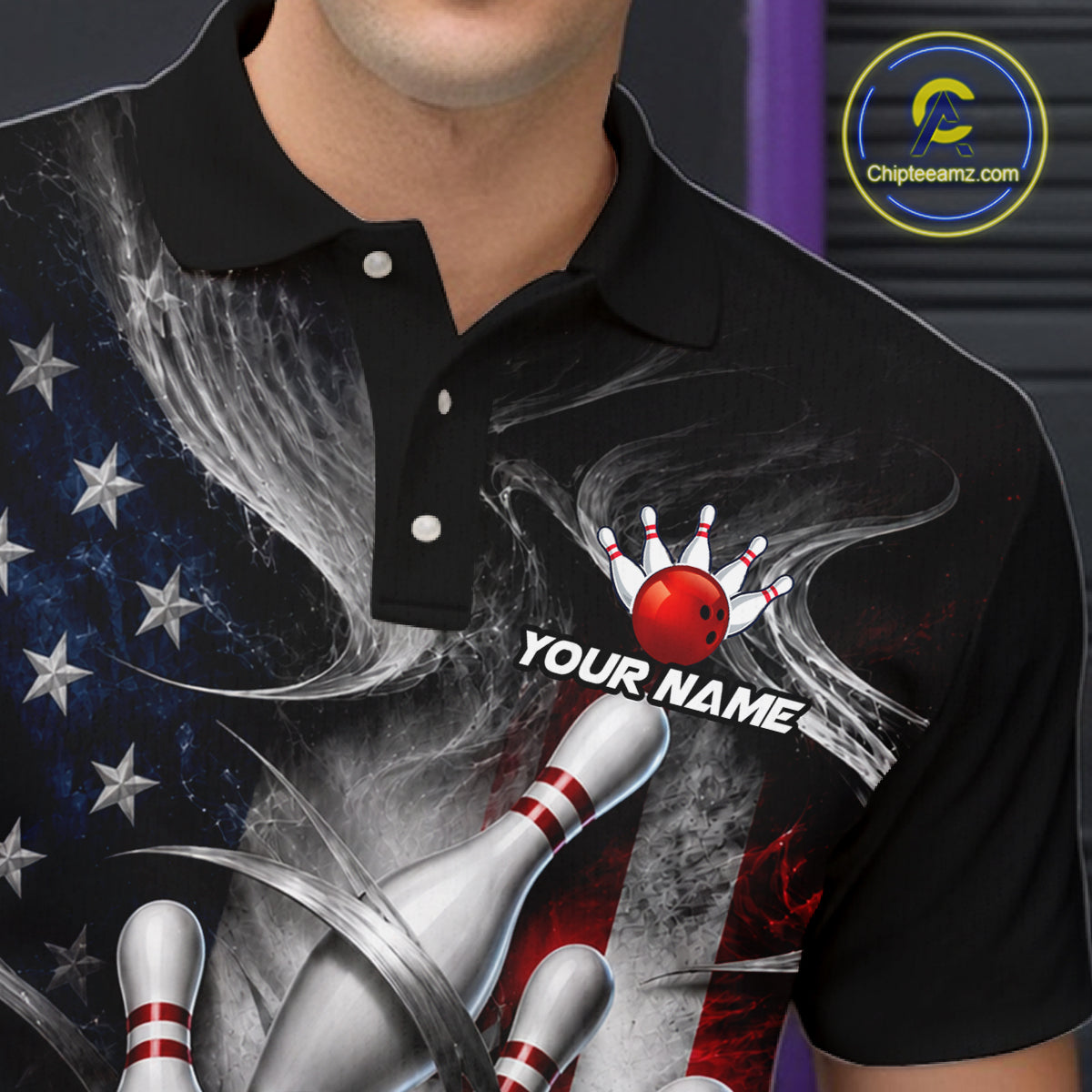 A close-up of a person wearing a black short-sleeve polo shirt with a custom bowling-themed graphic print. The design features a red bowling ball, white bowling pins, a silver bowling pin, a red and white American flag motif, and the text 'YOUR NAME'.