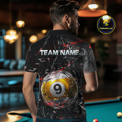 Man wearing a black collared polo shirt with shattered glass graphics, red accent streaks, a custom name area, and a large cracked 9-ball illustration across the lower back.