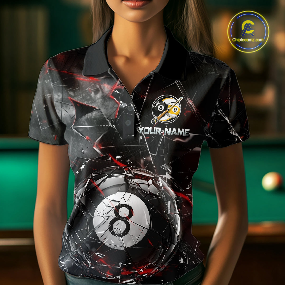 Woman wearing a black collared polo shirt with shattered glass graphics, red accent streaks, a custom name area, and a large cracked 8-ball illustration across the lower front.