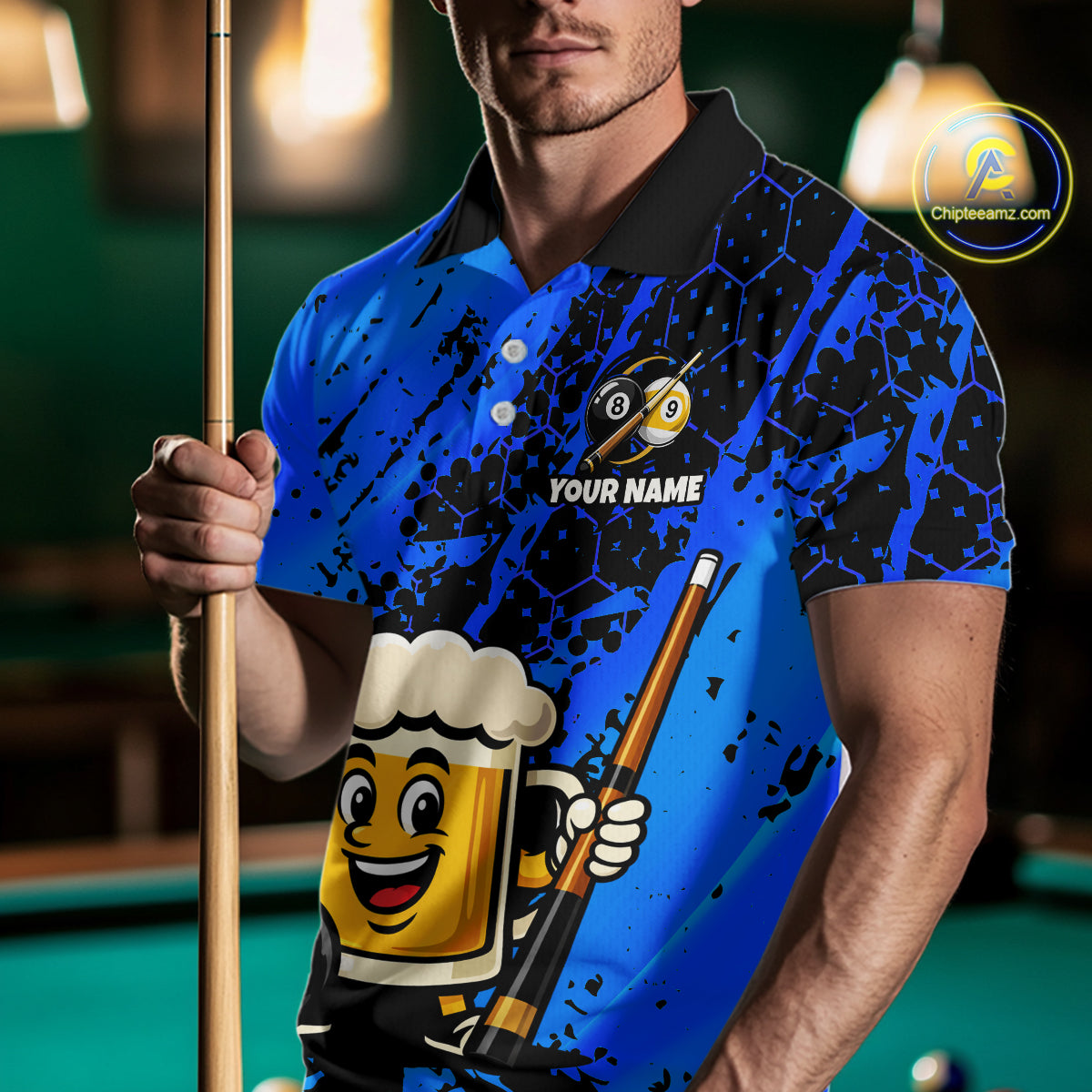 Man wearing a blue funny beer billiard shirt with a pool cue, standing in front of a pool table.