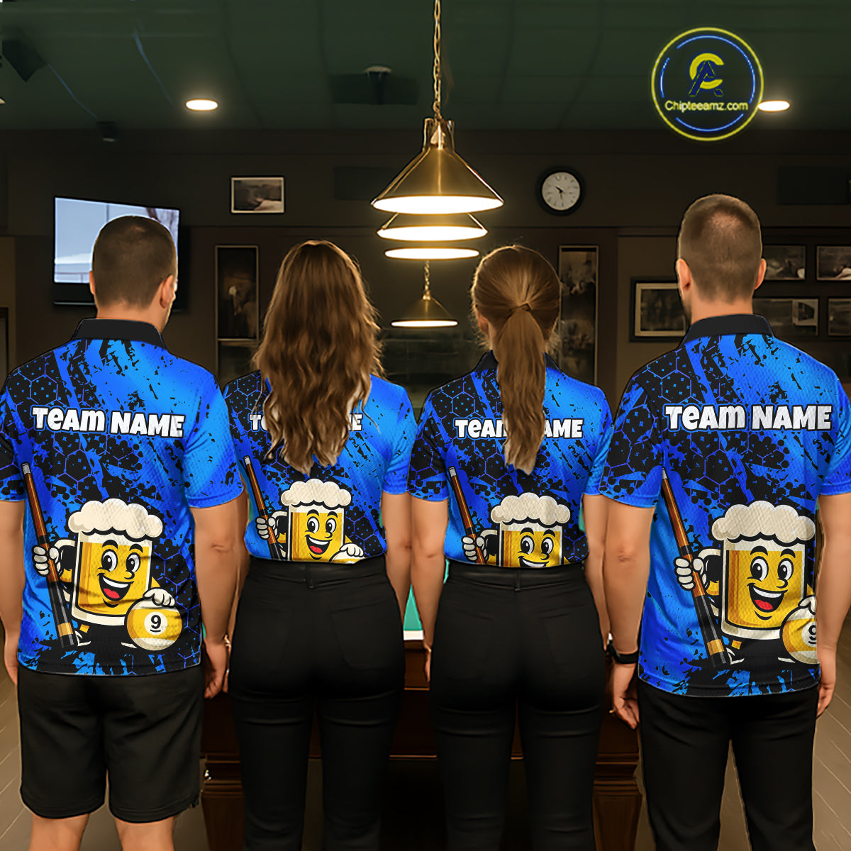 Four people wearing a bright blue billiards polo with black splatter graphics, custom “TEAM NAME” text, and a smiling beer mug mascot holding a pool cue.