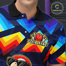 Load image into Gallery viewer, A close-up of a person wearing a short-sleeve polo shirt with a colorful geometric pattern in blue, yellow, red, and orange on a dark navy base. The shirt has a black collar, white buttons, a bowling ball graphic with pins, and the text 'YOUR NAME' on the chest.