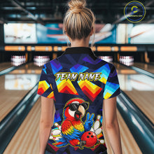 Load image into Gallery viewer, A woman viewed from behind wearing a short-sleeve bowling-themed polo shirt with a colorful geometric pattern and a large parrot graphic on the back, standing in a bowling alley.