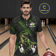 Load image into Gallery viewer, Man wearing bowling polo shirt featuring a dinosaur standing among bowling pins and ball artwork on black green textured background.