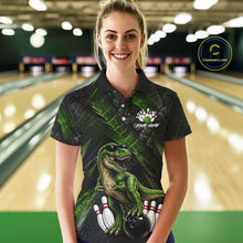 Load image into Gallery viewer, Women wearing bowling polo shirt featuring a dinosaur standing among bowling pins and ball artwork on black green textured background.