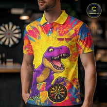 Load image into Gallery viewer, Man wearing darts polo shirt featuring a purple dinosaur holding a dartboard within a bright colorful paint splatter background.