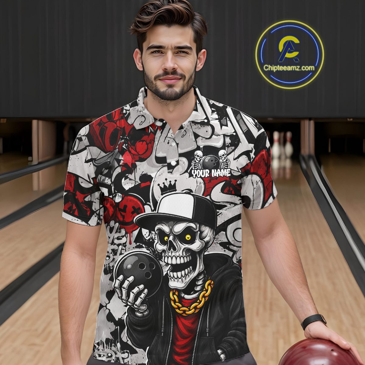 Man wearing a graphic shirt with a skeleton design holding a bowling ball in a bowling alley.