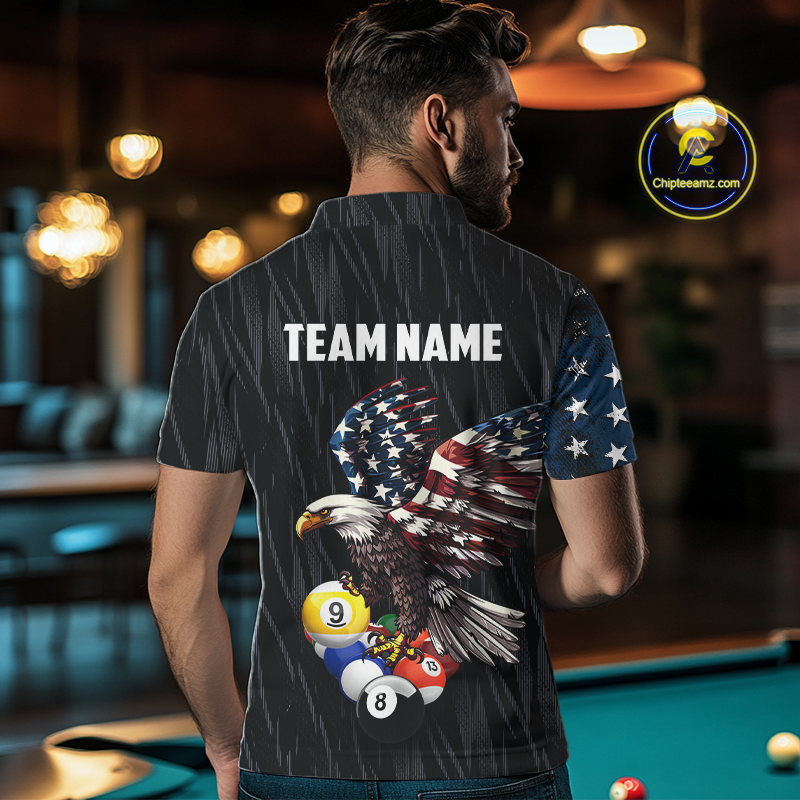 A man viewed from behind wearing a dark gray short-sleeve button-up shirt with a patriotic eagle and billiards graphic on the back, featuring the text 'TEAM NAME' and a customizable name field. The shirt has a distressed American flag pattern on the sleeves and a large bald eagle with billiards balls integrated into the graphic.