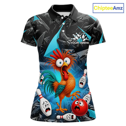 A women's short-sleeve polo shirt with a vibrant, all-over cartoon print featuring a startled rooster and bowling pins/balls on a blue and black background. The shirt has a black collar and sleeve cuffs, a button placket, and 'YOUR NAME' printed on the chest as a customization placeholder.