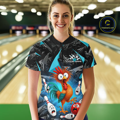 A woman stands in a bowling alley wearing a custom-designed bowling shirt with a cartoon rooster and bowling pins graphic. The shirt has a black and blue geometric pattern with a colorful central illustration.
