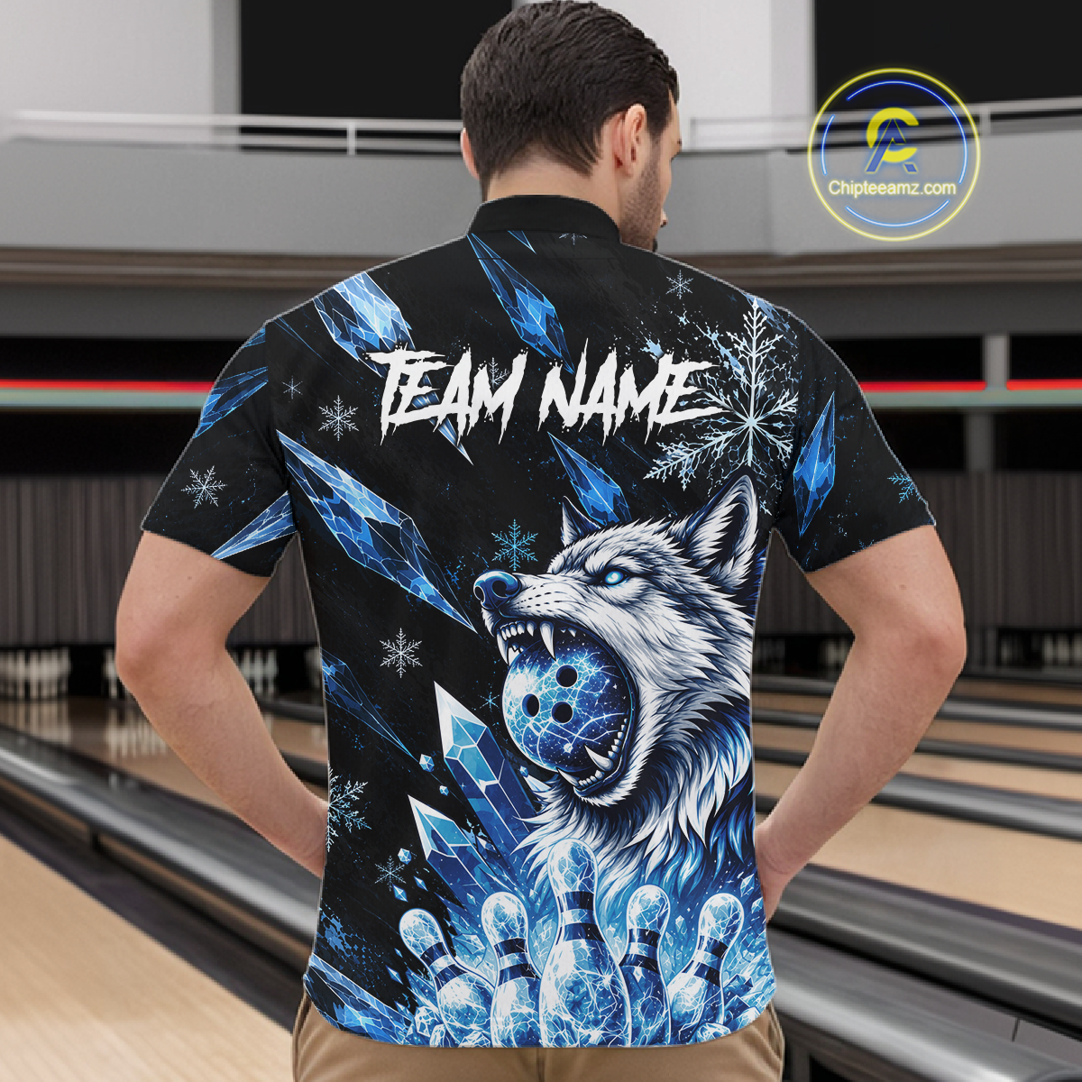 Person wearing a black t-shirt with a blue wolf design and 'TEAM NAME' text in a bowling alley.