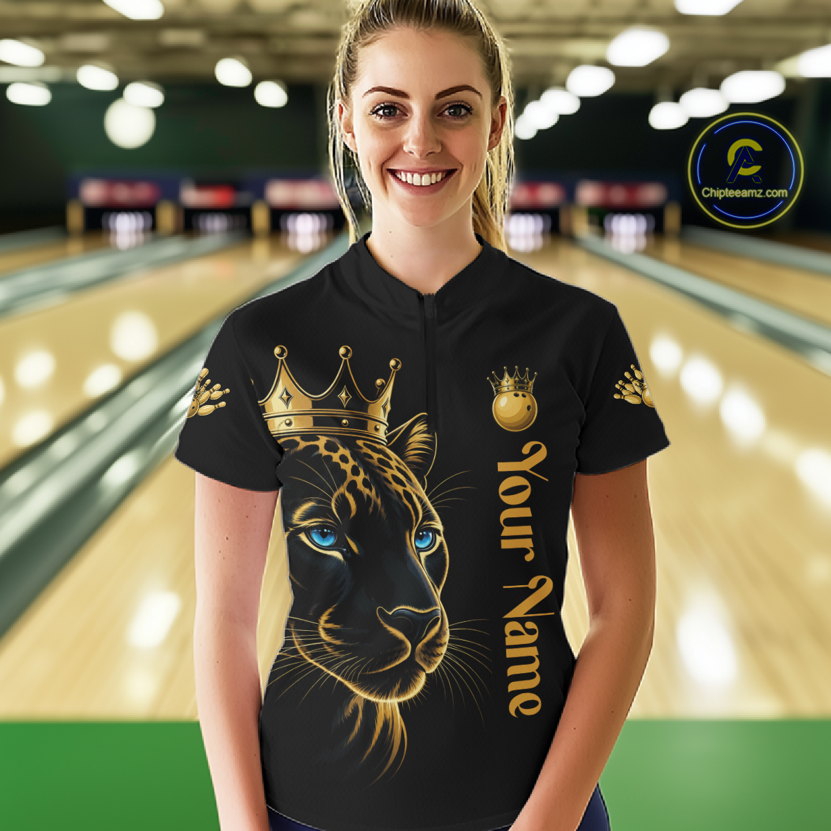 Woman wearing a black shirt with a gold panther design and 'Your Name' text in a bowling alley.