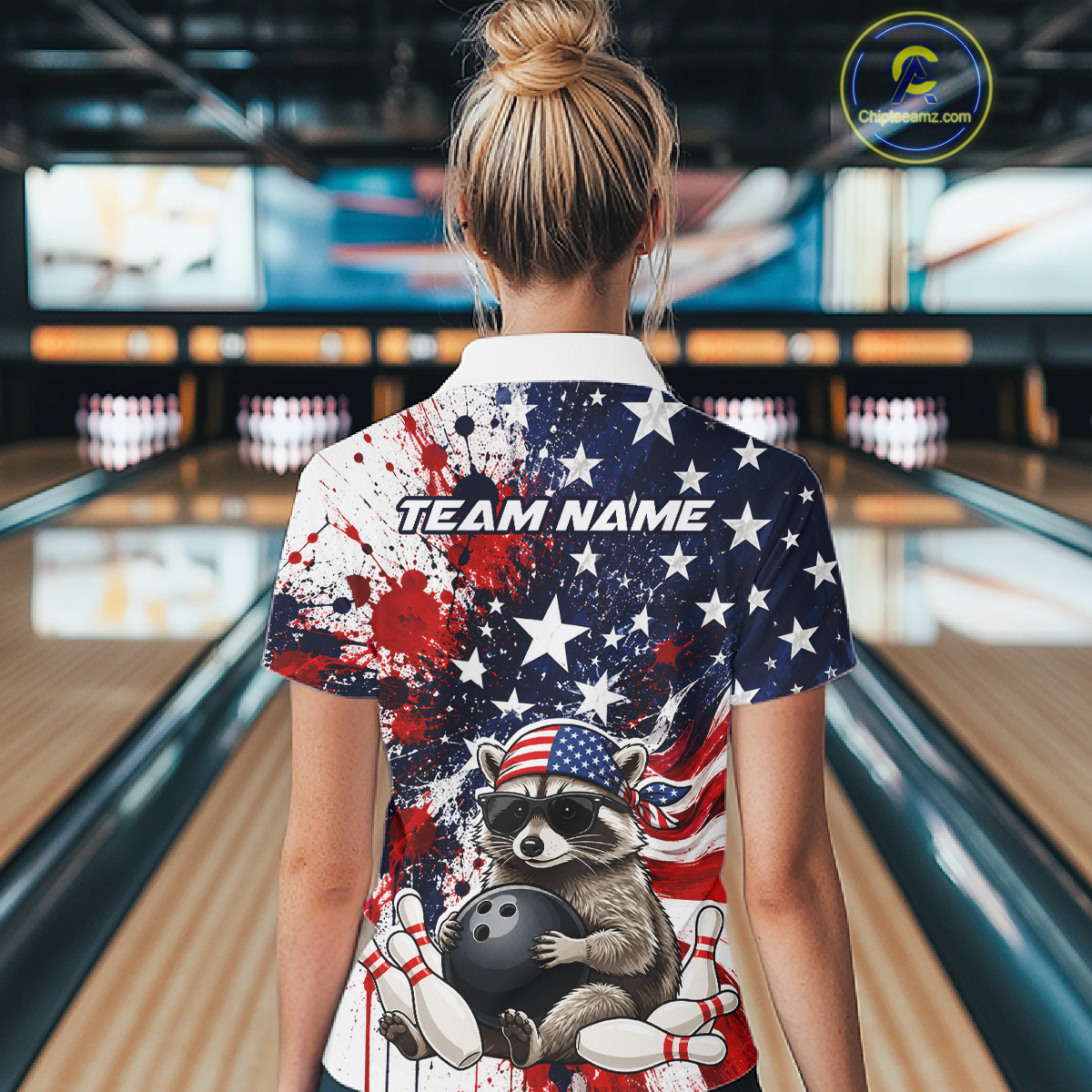 Women’s us flag raccoon bowling polo shirt, back view on female model in bowling lane 