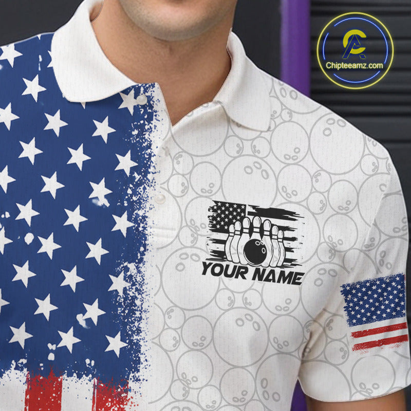 A close-up of a man wearing a white short-sleeve polo shirt with a distressed American flag design on the left side, a bowling pin graphic with the text 'YOUR NAME' on the chest, and a small American flag patch on the sleeve. 